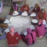 Village women cleaning rice for dham