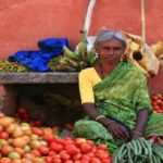 Poor lady selling fruits in india